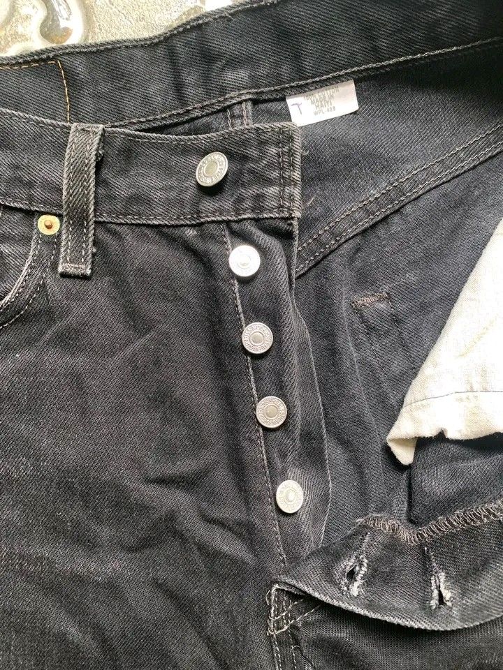 Levi's 501 Black Denim Shorts (Category: Shorts) located in Butuan. Submitted by markystuffs23 (Listing ID 1426372666, Image 3). Description: Authentic Levi's 501 black denim shorts. Features a button fly and the classic Levi's red tab on the back pocket. The shorts have a raw hem. The size is 31x32. The shorts have a vintage look..