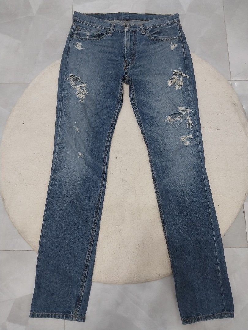 Levi's 511 Tattered Jeans (Category: Jeans) located in Malaybalay. Submitted by markdaumar08466 (Listing ID 1426217301, Image 1). Description: Levi's 511 jeans in a distressed style. Features a classic five-pocket design with a button and zipper closure. The jeans have a faded blue wash with intentional distressing on the front and back. The Levi's logo patch is visible on the back. Size is W32 L34..