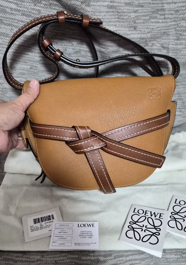 Loewe Gate Small Bag Light Calf Skin (Category: Luxury Bags & Wallets) located in Quezon City. Submitted by marya_s (Listing ID 1426283836, Image 1). Description: Authentic Loewe Gate Small Bag in a beautiful tan color. Features a distinctive knotted front detail and a crossbody strap. The bag includes the original dust bag, tags, and authenticity cards. The interior is lined with suede and has a Loewe logo. comes woth dustbag and loewe papers.