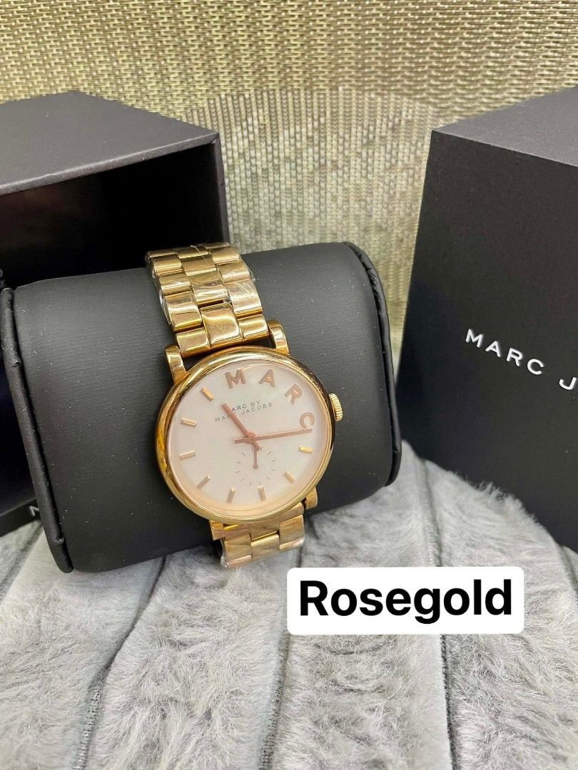 Marc Jacobs Rosegold Watch (Category: Women's Watches) located in Bulacan. Submitted by yukionnana (Listing ID 1426262444, Image 2). Description: ‼️SALE‼️SALE‼️ SALE‼️ 2,950 w/Box ( size 38’mm)+ SF Marc Jacobs watch features a rosegold finish. The watch has a white dial with rosegold hands and markers. The watch comes with its original box. The band is made of metal and has a clasp closure. The watch is a stylish accessory for everyday wear..