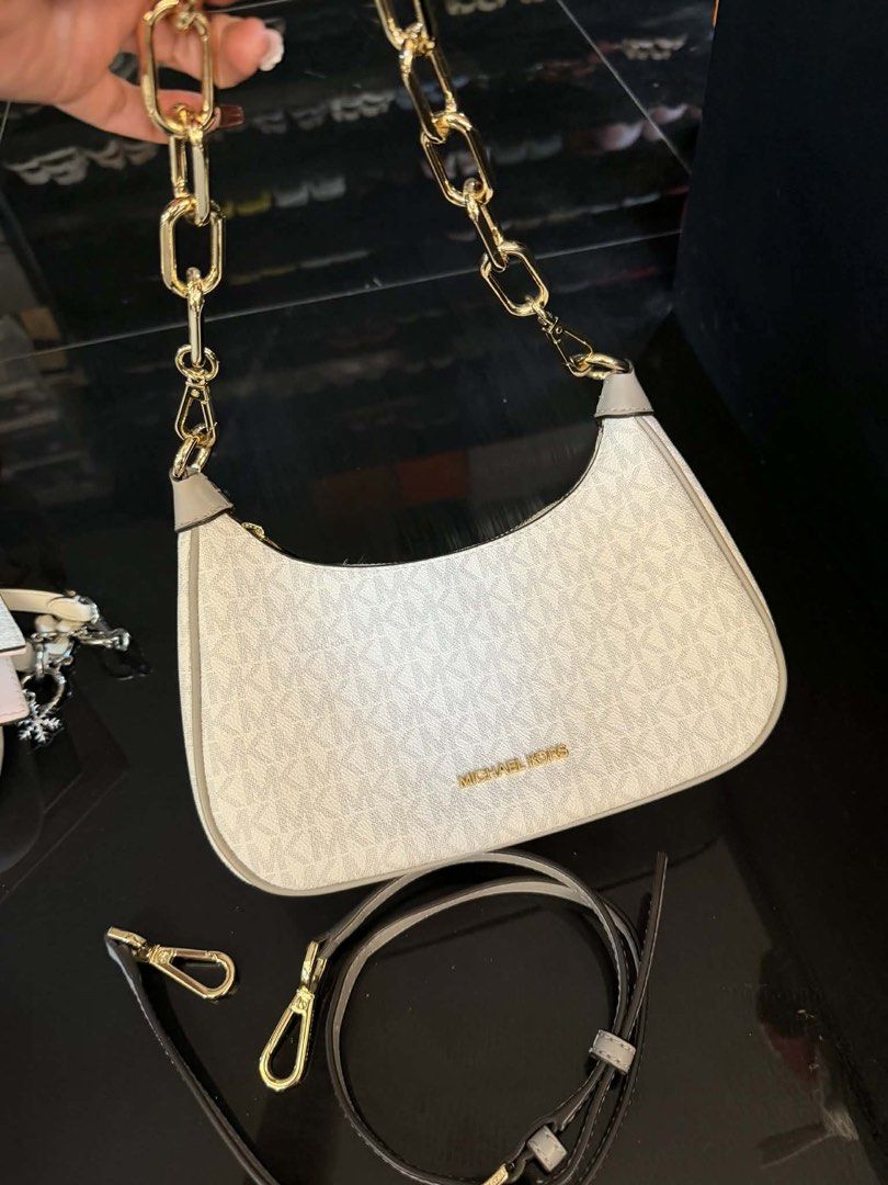 Michael Kors Shoulder Bag (Category: Luxury Bags & Wallets) located in Manila. Submitted by charensancho (Listing ID 1426247120, Image 1). Description: Michael Kors shoulder bag features a white monogram pattern and a gold chain strap. It includes an additional adjustable strap for versatility. The bag has a curved design and a gold Michael Kors logo. Negotiable.