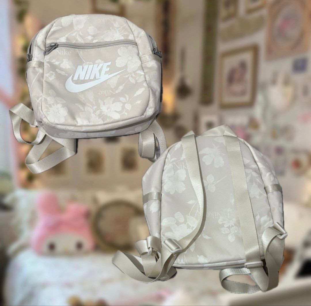 Nike Mini Backpack (Category: Backpacks) located in Manila. Submitted by sofiaax (Listing ID 1426275589, Image 2). Description: -can fit all ur essentials ! -cream/off white color -great for gym days or casual errands -condition: 9/10 (has a few stains at the top, washable) payment: gcash / cash can do meetup around manila ! delivery: j&t or lalamove :) tags: nike mini floral print backpack athleisure sportswear alo adidas essentials activewear.
