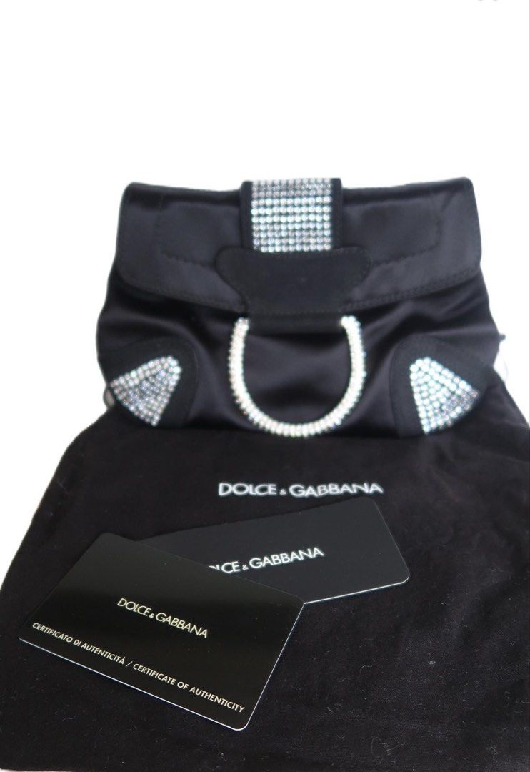Pre-owned Dolce & Gabbana Black Embellished Chain Bag (Category: Luxury Bags & Wallets) located in Leyte. Submitted by feleanastore_955 (Listing ID 1426185360, Image 2). Description: Add a touch of timeless luxury to your collection with this authentic Dolce & Gabbana evening bag, exquisitely crafted from black satin and finished with calfskin suede leather piping. ✨ Condition Please note: the small metal ring that holds the chain strap shows tar