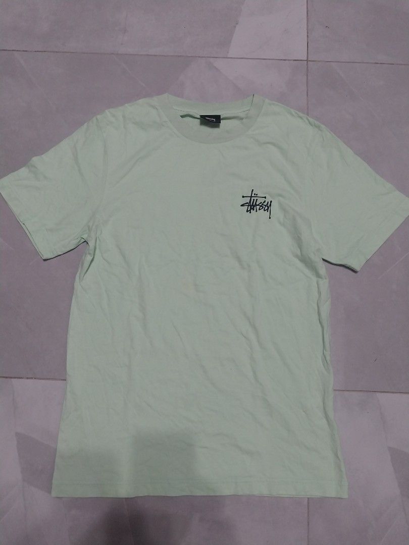 Stussy T-shirt - Mint Green (Category: Tshirts & Polo Shirts ) located in Malaybalay. Submitted by markdaumar08466 (Listing ID 1426301014, Image 1). Description: Mint green Stussy T-shirt. Features the Stussy logo on the front and back. Made in Mexico. Size S. The shirt is made of 100% cotton. Care instructions include machine wash cold, tumble dry low, and do not dry clean..