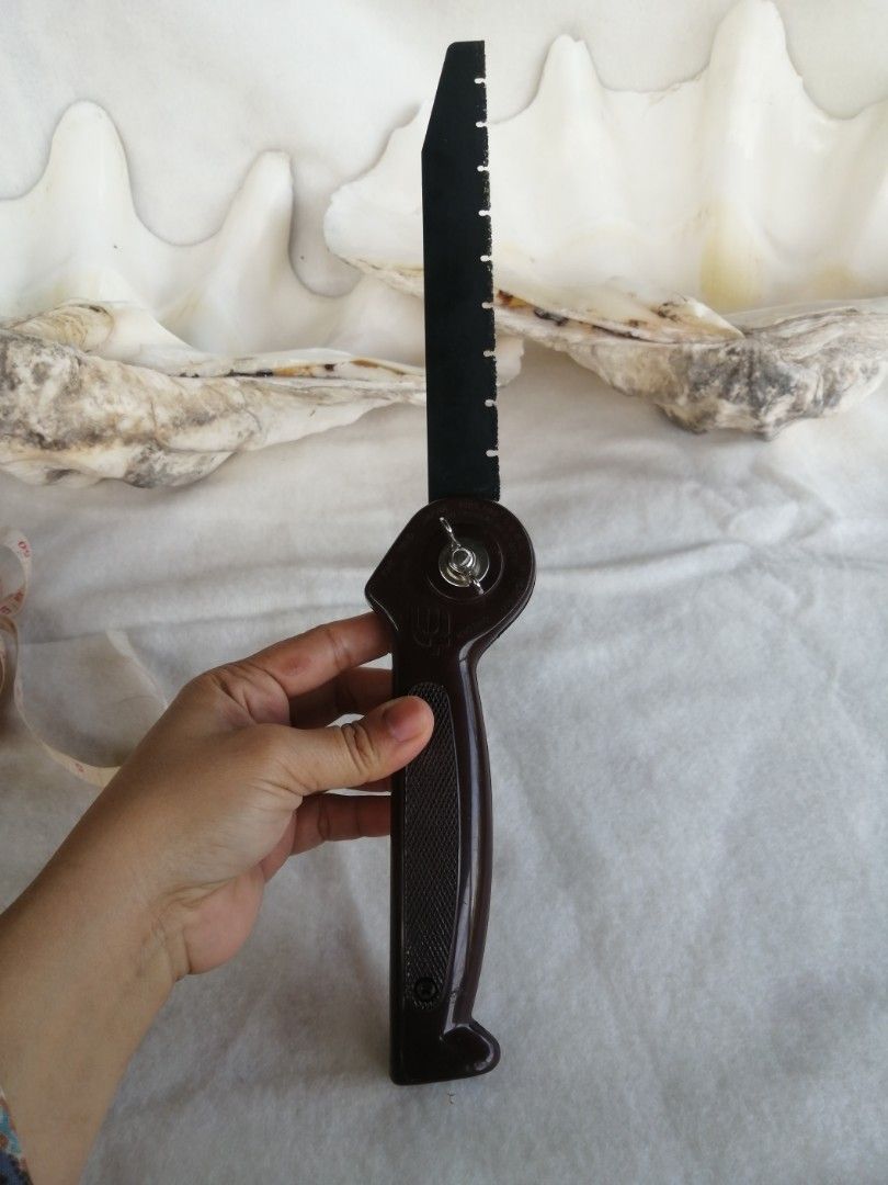 Vintage Folding Hand Saw Japan (Category: Construction Tools & Equipment) located in Liloan. Submitted by aidolcapz88 (Listing ID 1426253985, Image 2). Description: Vintage folding hand saw. Features a brown handle and a black blade. The blade can be folded into the handle. Great for camp survival or hunting. The saw has a unique design with a circular mechanism for folding.Size blade 7.5".blade to handle 15"..bagay to sa my garden pang pruning p