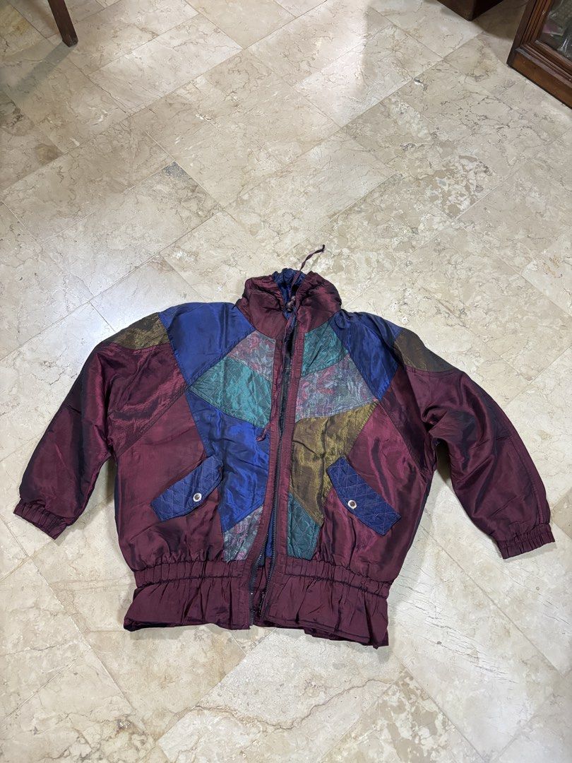 Vintage Patchwork Jacket (Category: Coats, Jackets and Outerwear) located in Alicia. Submitted by rangelenem23336 (Listing ID 1426297648, Image 1). Description: Vintage jacket features a unique patchwork design with various colors and textures. It has a zip-up front, two pockets, and elastic cuffs and hem. The jacket has a quilted lining for added warmth. It is a stylish and eye-catching piece perfect for adding a pop of color to any outfit. 📏sh