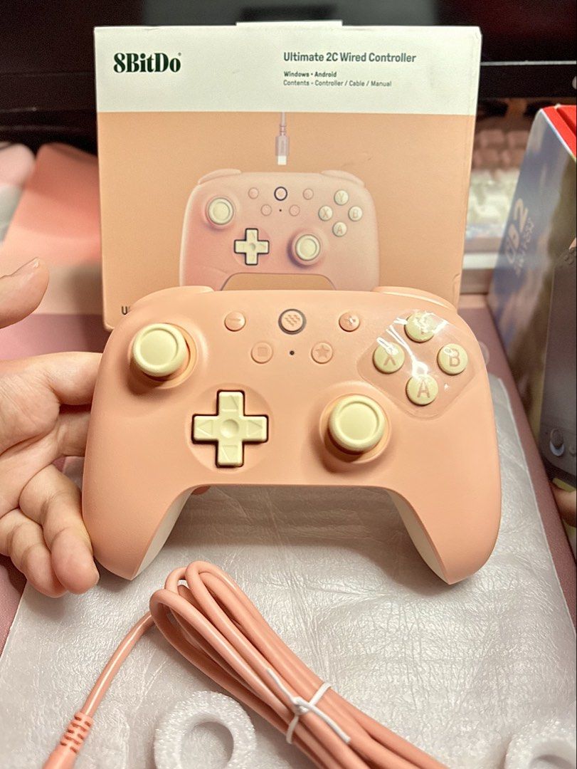 8BitDo Ultimate 2C Wired Controller (Category: Controllers) located in Bulacan. Submitted by ringingbellss (Listing ID 1426518923, Image 1). Description: Peach edition 8BitDo Ultimate 2C Wired Controller for Windows and Android. Includes the controller, USB cable, and original box. The controller has a peach and cream color scheme. Bought from PixelPlay Selling as is. Buyer shoulders sf. Seller is not liable for any damages. All buttons are worki