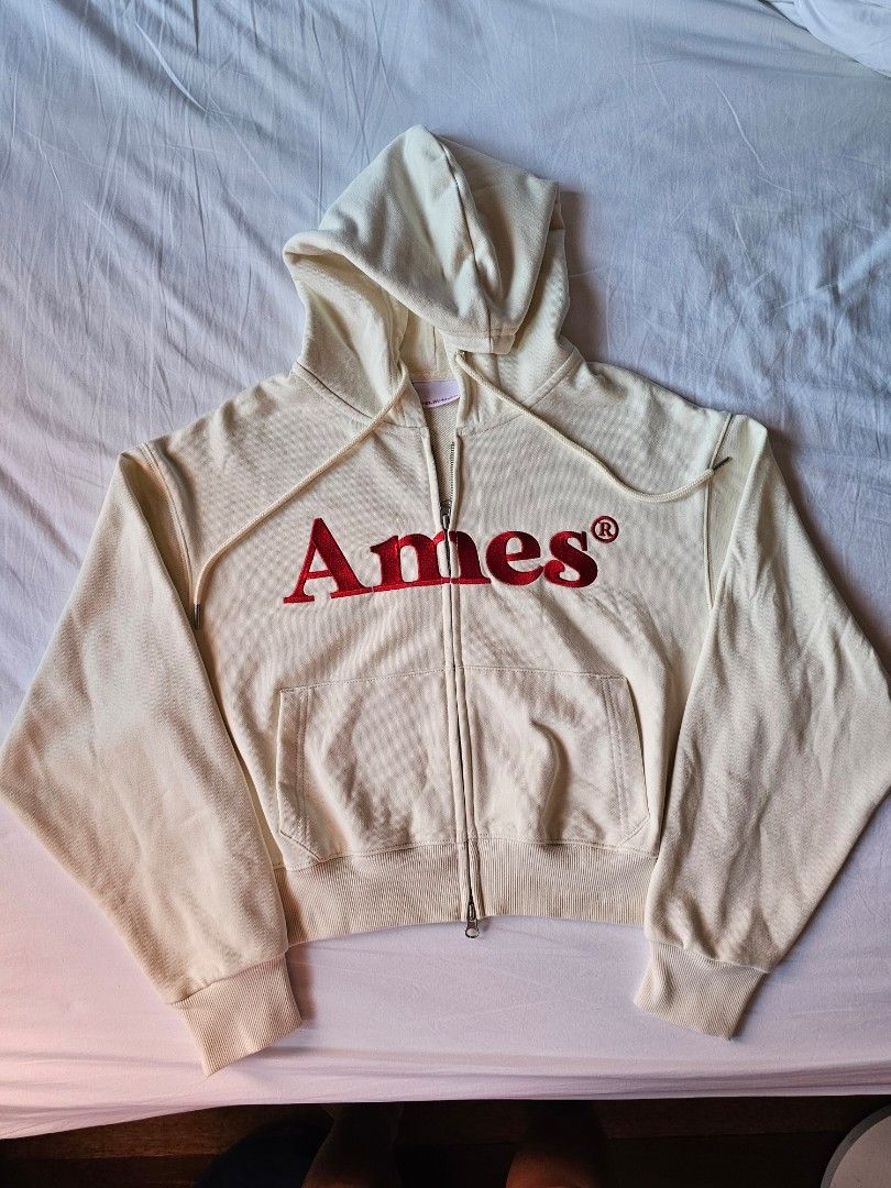 Ames Zip Hoodie Jacket Basic Logo Cream Size Small/Crop (Category: Coats, Jackets and Outerwear) located in Pateros City. Submitted by dengatron (Listing ID 1426504306, Image 1). Description: Ames Zip Hoodie Cream color with red embroidered logo Size Small/Crop (see dimensions in last photo) Brand new condition Removed tags but never used Authentic Bought from Korea RFS: maliit sa akin so I bought larger size No meetups for this item Delivery fee