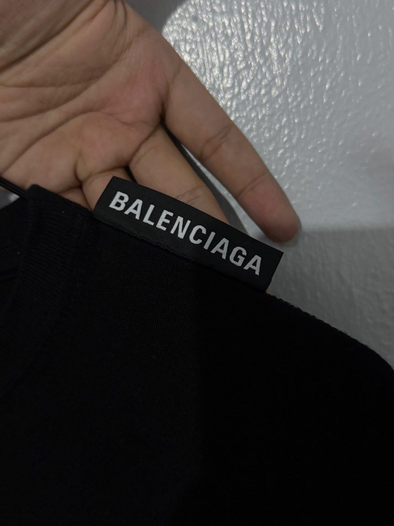 Balenciaga Black T-shirt (Authentic) (Category: Luxury Apparel) located in Bulacan. Submitted by hilligna (Listing ID 1426505374, Image 2). Description: Authentic Balenciaga black t-shirt. Features the Balenciaga logo on the neck and tag. Made in Portugal. Size M. The t-shirt has a classic crew neck and short sleeves. It is a versatile piece that can be dressed up or down. Perfect for everyday wear. Brandnew Condition Size M can Fit to Large.