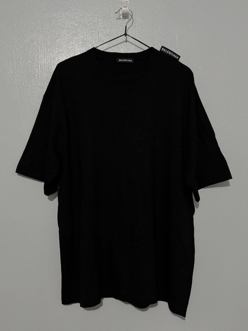 Balenciaga Black T-shirt (Authentic) (Category: Luxury Apparel) located in Bulacan. Submitted by hilligna (Listing ID 1426505374, Image 1). Description: Authentic Balenciaga black t-shirt. Features the Balenciaga logo on the neck and tag. Made in Portugal. Size M. The t-shirt has a classic crew neck and short sleeves. It is a versatile piece that can be dressed up or down. Perfect for everyday wear. Brandnew Condition Size M can Fit to Large.