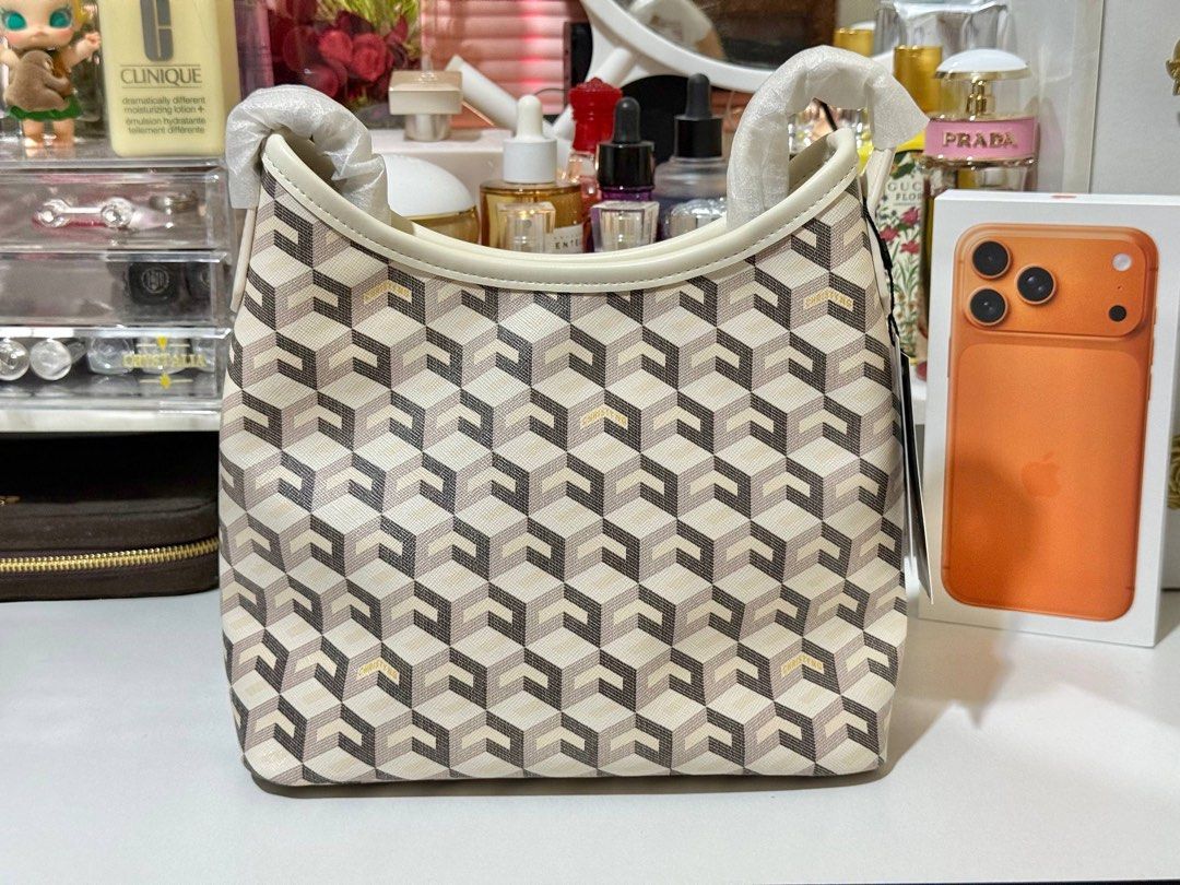 Christy Ng Alesso Mini in White (Category: Luxury Bags & Wallets) located in Manila. Submitted by cjonlineshop.10 (Listing ID 1426419056, Image 1). Description: Stylish shoulder bag featuring a unique geometric pattern. The bag has a cream-colored trim and handles. The bag is a good size for everyday use..