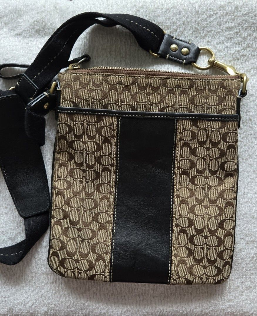 Coach Signature Crossbody Bag (Category: Luxury Bags & Wallets) located in Quezon City. Submitted by dymc25 (Listing ID 1426419009, Image 2). Description: Coach Signature Crossbody Swingpack bag. This specific vintage style features the classic Coach "C" monogram pattern on canvas with a vertical leather stripe down the center, accented by a gold-tone Coach-branded butt Product Details Brand: Coach Style: Signature Crossbody / Swingpack Materials