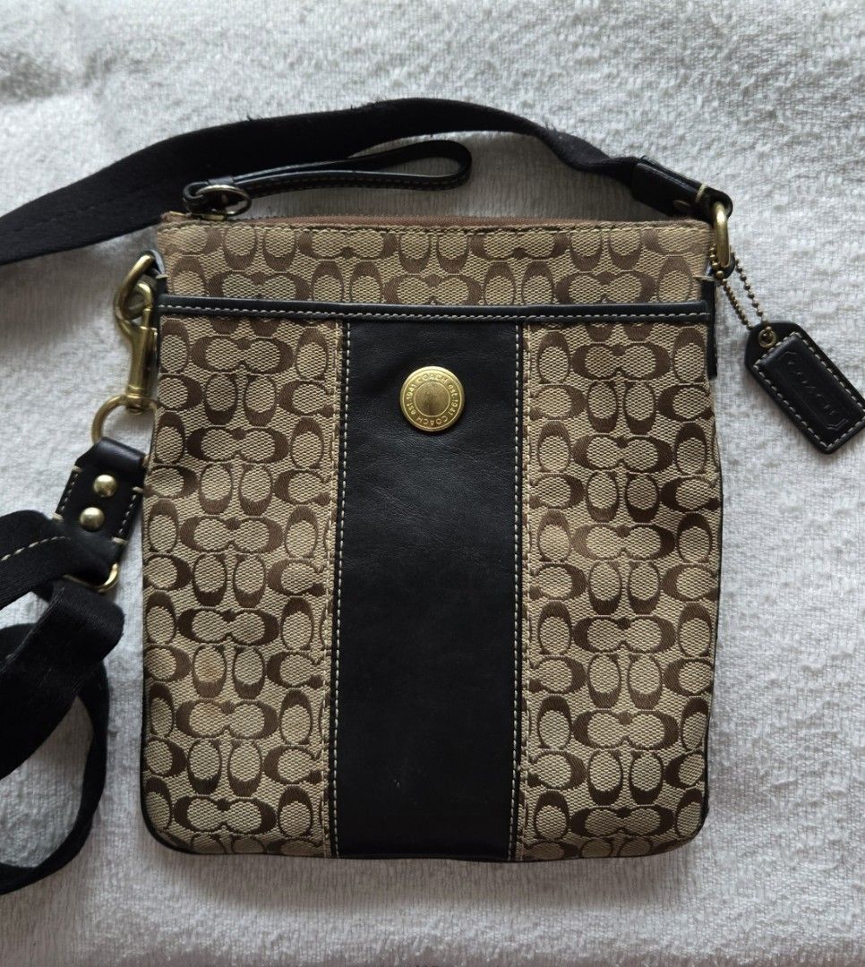 Coach Signature Crossbody Bag (Category: Luxury Bags & Wallets) located in Quezon City. Submitted by dymc25 (Listing ID 1426419009, Image 3). Description: Coach Signature Crossbody Swingpack bag. This specific vintage style features the classic Coach "C" monogram pattern on canvas with a vertical leather stripe down the center, accented by a gold-tone Coach-branded butt Product Details Brand: Coach Style: Signature Crossbody / Swingpack Materials