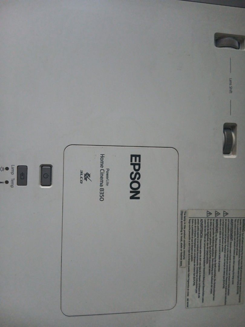 Epson Home Cinema 8350 Projector (Category: Projectors) located in Las Pinas. Submitted by 030700 (Listing ID 1422272752, Image 3). Description: - Epson Home Cinema 8350 projector - Includes power cable - Features lens adjustment dial - White unit - Epson logo visible - Model number clearly printed - Manual and remote control !!! Relocating/Moving Soon !!! Most items posted have been stored for a decade or longer hence the discoloration or stain 