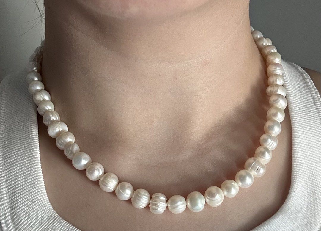 Freshwater Pearl Necklace with Silver Clasp (Category: Necklaces) located in Pasig City. Submitted by fifinds2020 (Listing ID 1426459293, Image 2). Description: Elegant pearl necklace featuring lustrous, off-white freshwater pearls. The necklace is secured with a silver clasp. The pearls have a unique, slightly irregular shape, adding to their natural beauty. This necklace is perfect for adding a touch of sophistication to any outfit..