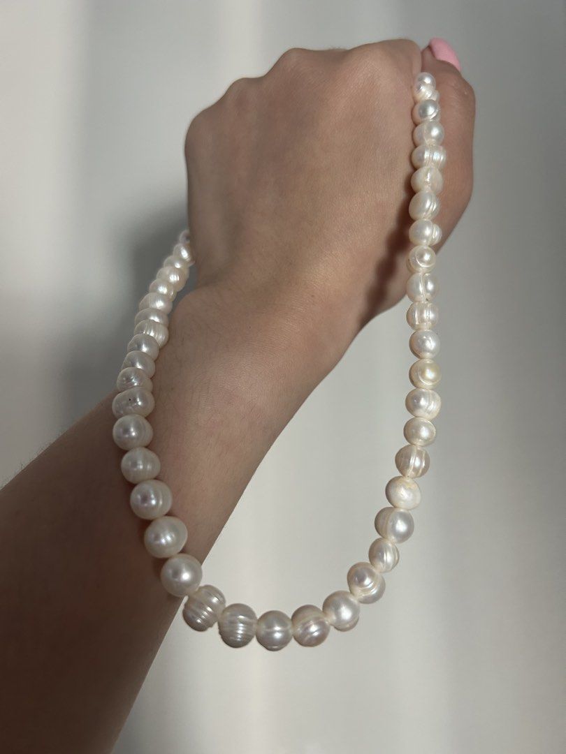 Freshwater Pearl Necklace with Silver Clasp (Category: Necklaces) located in Pasig City. Submitted by fifinds2020 (Listing ID 1426459293, Image 3). Description: Elegant pearl necklace featuring lustrous, off-white freshwater pearls. The necklace is secured with a silver clasp. The pearls have a unique, slightly irregular shape, adding to their natural beauty. This necklace is perfect for adding a touch of sophistication to any outfit..