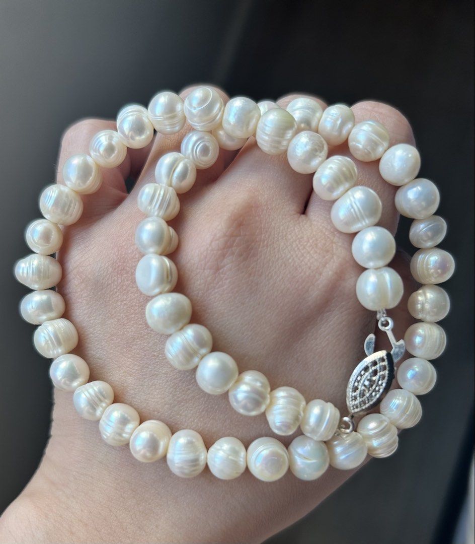Freshwater Pearl Necklace with Silver Clasp (Category: Necklaces) located in Pasig City. Submitted by fifinds2020 (Listing ID 1426459293, Image 1). Description: Elegant pearl necklace featuring lustrous, off-white freshwater pearls. The necklace is secured with a silver clasp. The pearls have a unique, slightly irregular shape, adding to their natural beauty. This necklace is perfect for adding a touch of sophistication to any outfit..