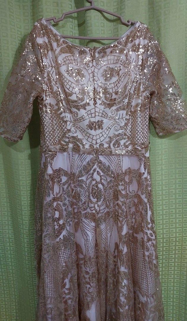 Gold Sequin Gown (Category: Evening dresses & gowns) located in Rizal. Submitted by zhellieme (Listing ID 1426516272, Image 2). Description: Elegant gold sequin gown with a V-neckline and half sleeves. Features intricate sequin detailing throughout the bodice and skirt. The dress has a zipper closure at the back. Perfect for formal events and special occasions. chest 40-42 waist 36-38.