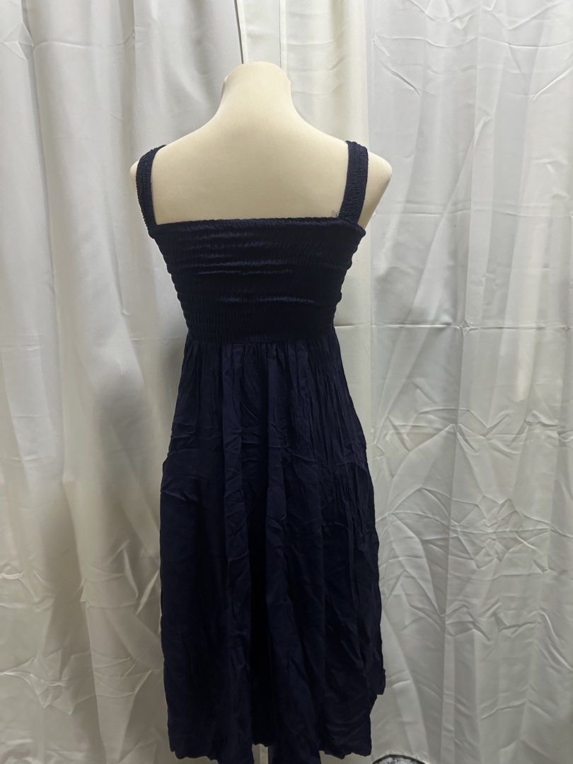 Navy Blue Smocked Dress (Category: Dresses) located in Manila. Submitted by randomdeclutter (Listing ID 1426560471, Image 2). Description: Navy blue dress features a smocked bodice and a flowing skirt. It has thick straps and a knee-length hemline. It has a simple, elegant design, perfect for casual outings or a relaxed summer day..