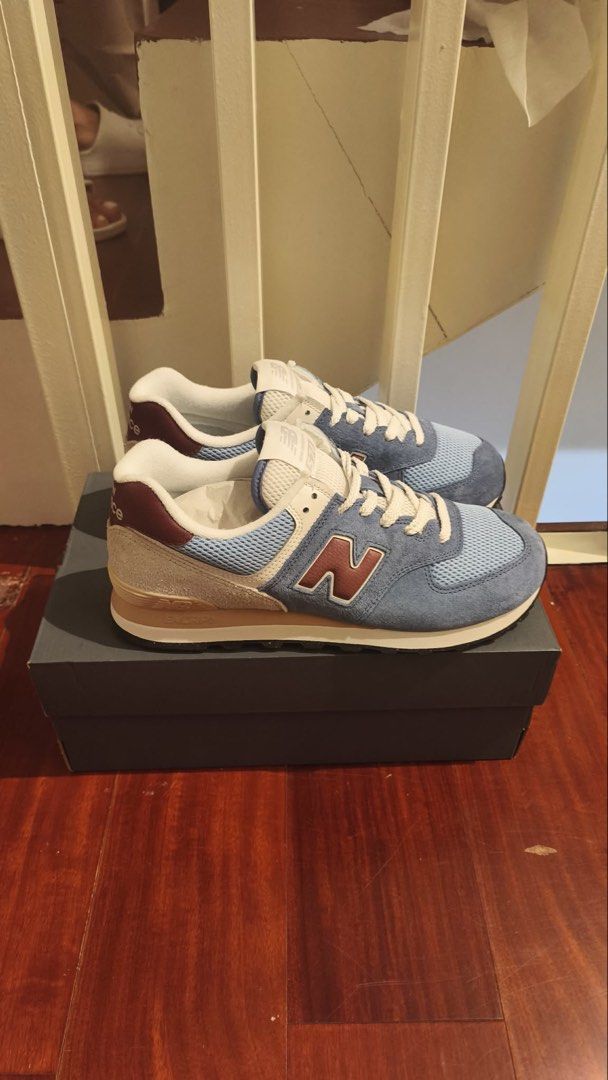 New Balance 574 Blue Sneakers (Category: Sneakers) located in Taguig. Submitted by declutterme12 (Listing ID 1426586865, Image 2). Description: Brandnew po Selling Below Market Price Size 9 New Balance 574 sneakers in blue. Features a mesh and suede upper with a classic design. The shoes have a white tongue and laces, with a maroon "N" logo on the side. The box is included. Size 9..