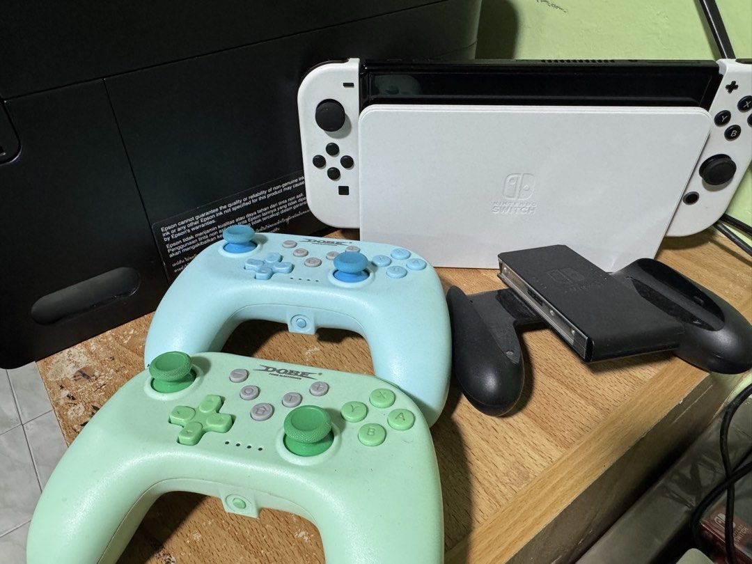 Nintendo Switch OLED (Category: Nintendo) located in Manila. Submitted by cyanide720 (Listing ID 1426256767, Image 3). Description: Nintendo Switch OLED Included: -Unit -Dock -HDMI cable -Charger -Joycon white -Joycon Grip -Dobe controllers 2 pcs RFS: upgrade.