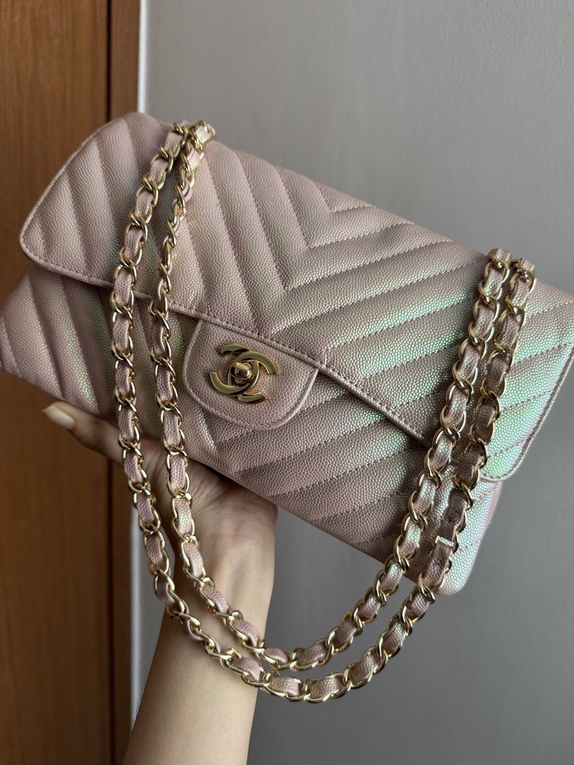 Rare Chanel Chevron Medium Flap Bag - Pink Iridescent (Category: Luxury Bags & Wallets) located in Pasig City. Submitted by gluxerare (Listing ID 1426445235, Image 2). Description: Super pretty bag ! 😍What you see is what you get! Chanel flap bag features a unique iridescent pink color with a chevron pattern. It has a gold chain strap and a classic CC turn-lock closure. The interior includes a main compartment and a zippered pocket. The bag's de