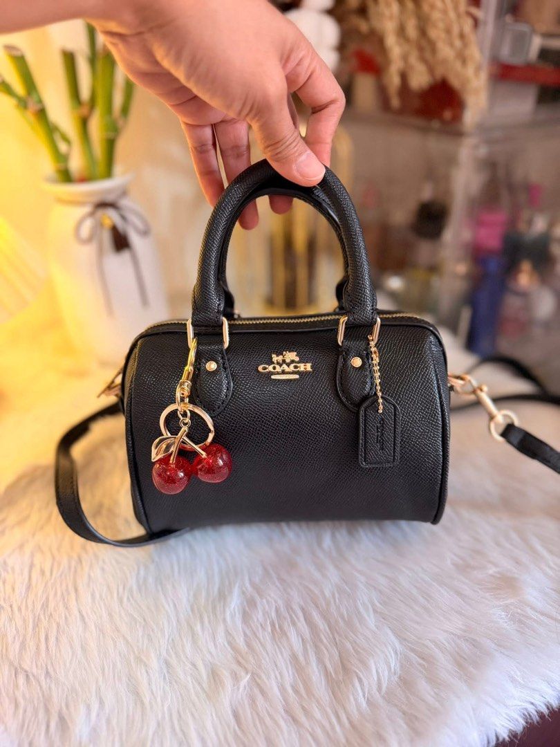 Rowan Coach Mini Cylinder Bag with Cherry Charm (Category: Luxury Bags & Wallets) located in Quezon City. Submitted by spikesforhope (Listing ID 1426552184, Image 1). Description: Rowan Coach 😍🖤🍒 made in vietnam ✔️ ykk zip/iteketa ✔️ Excellent condition ✔️ Dm for inquiries ❗️.