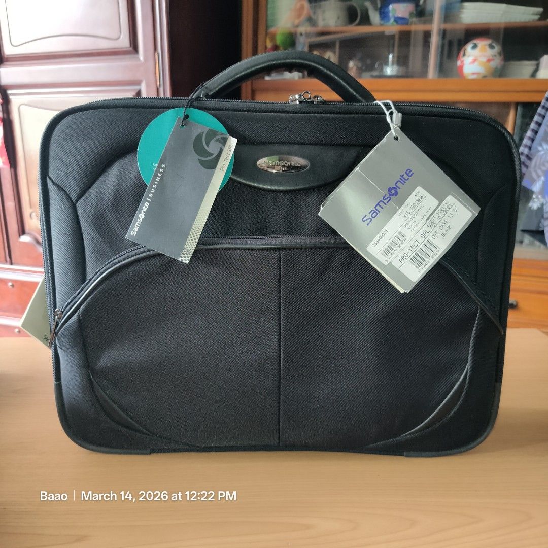Samsonite Pro-Tect SPL 15.6" Office Case (Category: Laptop Bags & Sleeves) located in Baao. Submitted by all.things.japan (Listing ID 1426426077, Image 1). Description: Samsonite Pro-Tect SPL office case is designed to carry a 15.6" laptop. -It features a black exterior with a handle and a detachable shoulder strap. -The interior has a padded compartment for the laptop and additional pockets for accessories. -The bag has a zipper closure and incl