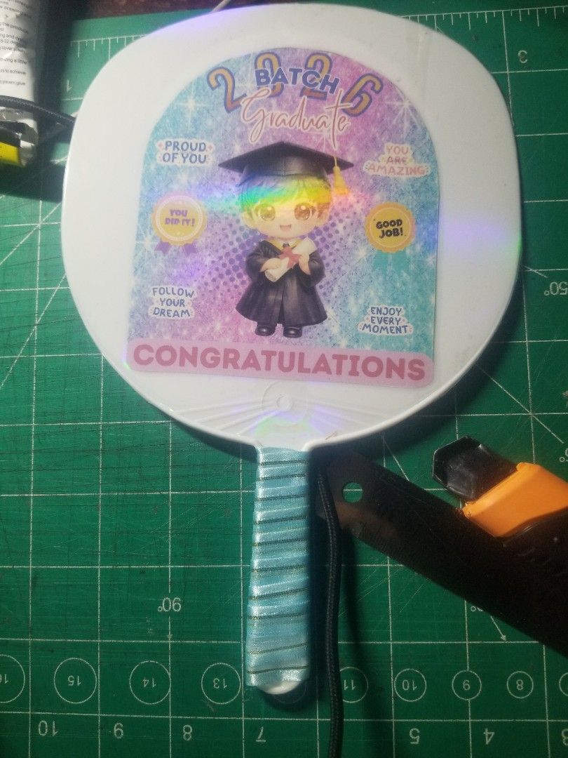 Souvenir Graduation Fan (Category: Fans) located in Dasmarinas. Submitted by makekiel0918 (Listing ID 1426572541, Image 2). Description: 🎓 GRADUATION FAN – Perfect for Graduation Day! 🎓 Celebrate your graduate with this cute Batch 2026 Graduation Fan! Perfect souvenir and useful to keep cool during the ceremony. ✨ Details: • Lightweight handheld fan • Cute graduation design • Perfect for graduation photos & gifts • Ready for Batch 2026 💰 Price