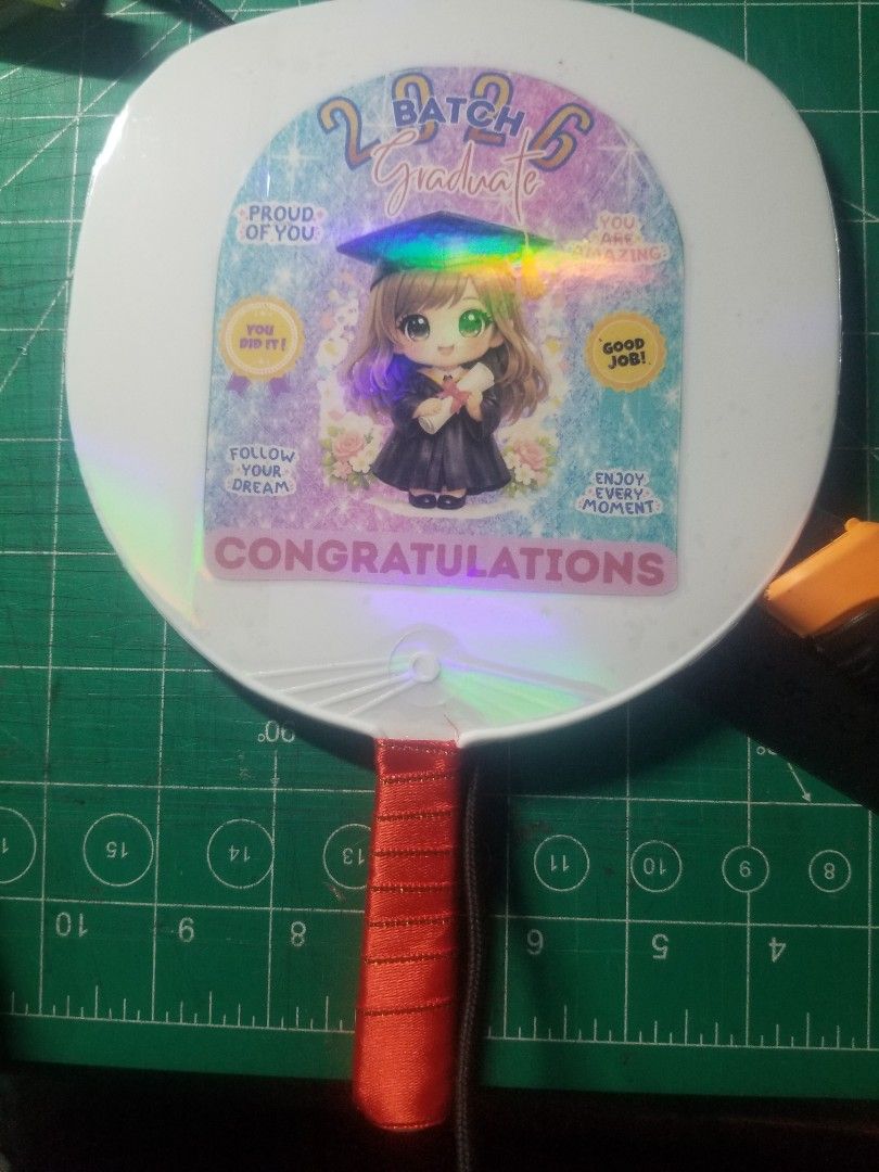 Souvenir Graduation Fan (Category: Fans) located in Dasmarinas. Submitted by makekiel0918 (Listing ID 1426572541, Image 1). Description: 🎓 GRADUATION FAN – Perfect for Graduation Day! 🎓 Celebrate your graduate with this cute Batch 2026 Graduation Fan! Perfect souvenir and useful to keep cool during the ceremony. ✨ Details: • Lightweight handheld fan • Cute graduation design • Perfect for graduation photos & gifts • Ready for Batch 2026 💰 Price