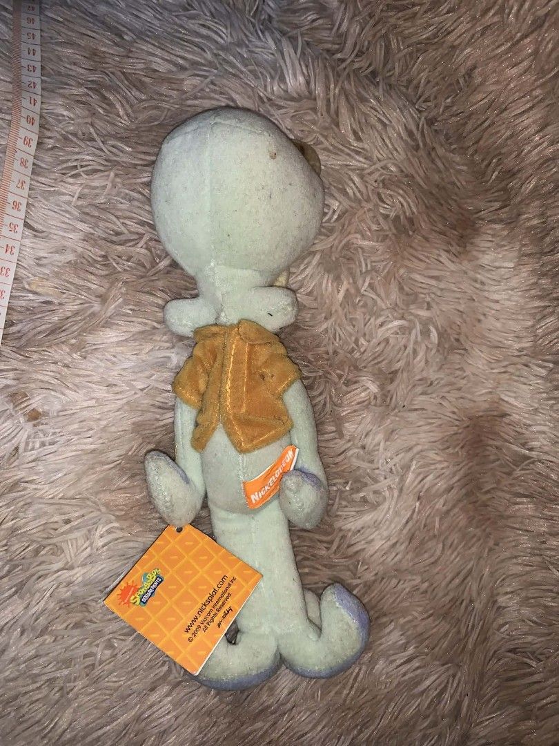 Squidward Plush Toy by Taito (Category: Plushies & Soft Toys) located in Davao. Submitted by shopthrift (Listing ID 1426451892, Image 2). Description: Squidward plush toy is a collectible item. It features Squidward in his classic outfit. The toy has a tag from Taito. It is a great addition to any SpongeBob SquarePants collection. The plush is soft and cuddly, perfect for display or play..