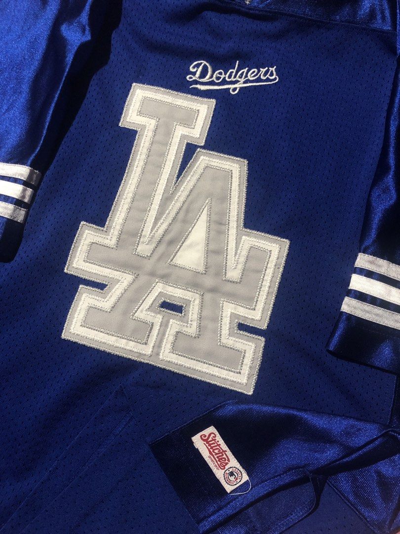 Stitches Los Angeles Dodgers Jersey - Medium (Category: Activewear) located in Manila. Submitted by bakithrift213 (Listing ID 1426438349, Image 3). Description: Authentic Stitches Los Angeles Dodgers jersey. Features the iconic "LA" logo on the front and "LOS ANGELES" on the back. It has a blue body with white and grey accents. The jersey is a medium size and made in China. Perfect for any Dodgers fan!.