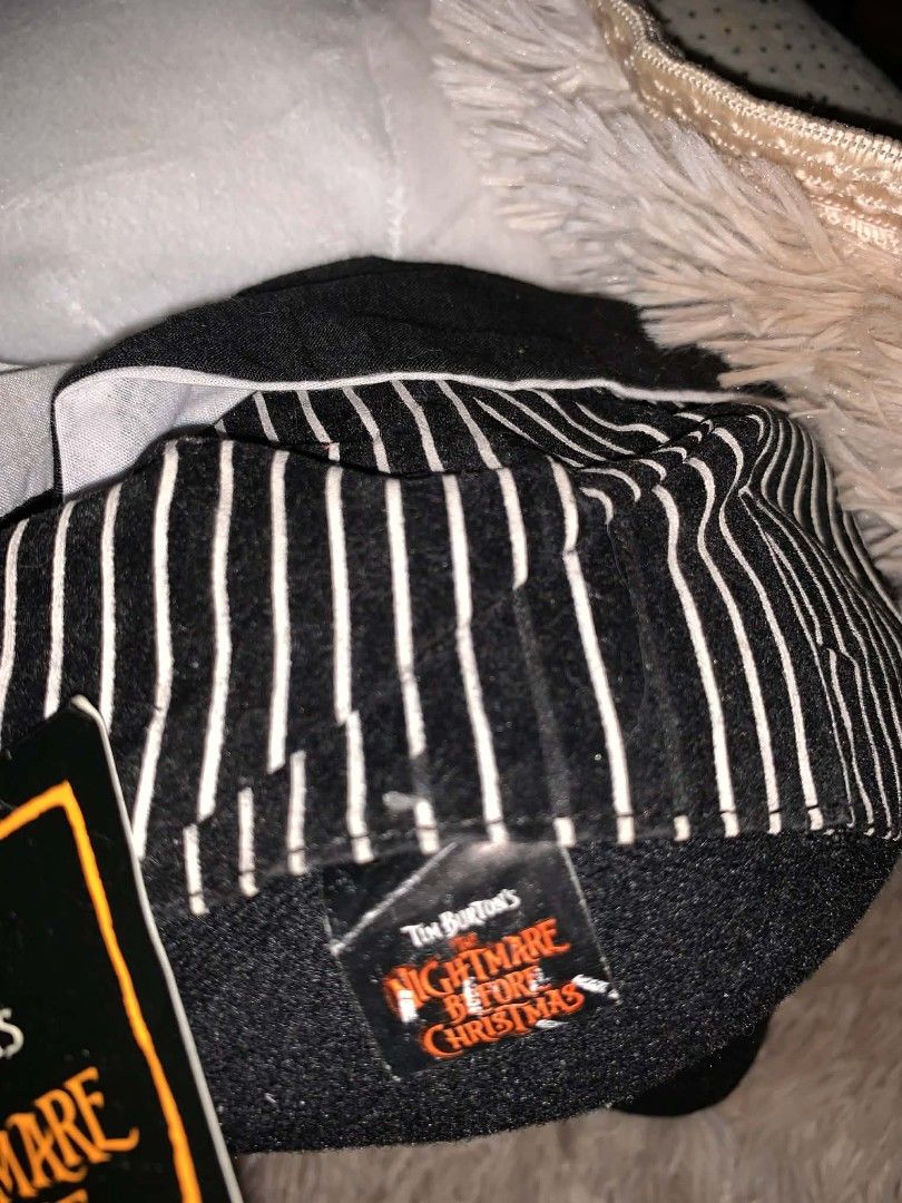Tim Burton's The Nightmare Before Christmas Jack Plush (Category: Plushies & Soft Toys) located in Davao. Submitted by shopthrift (Listing ID 1426450992, Image 2). Description: Plush toy features Jack Skellington from Tim Burton's The Nightmare Before Christmas. It has a round head with large black eyes and a stitched mouth. Jack is wearing his signature black and white striped suit. The toy has a tag attached. It is a great collectible item for 