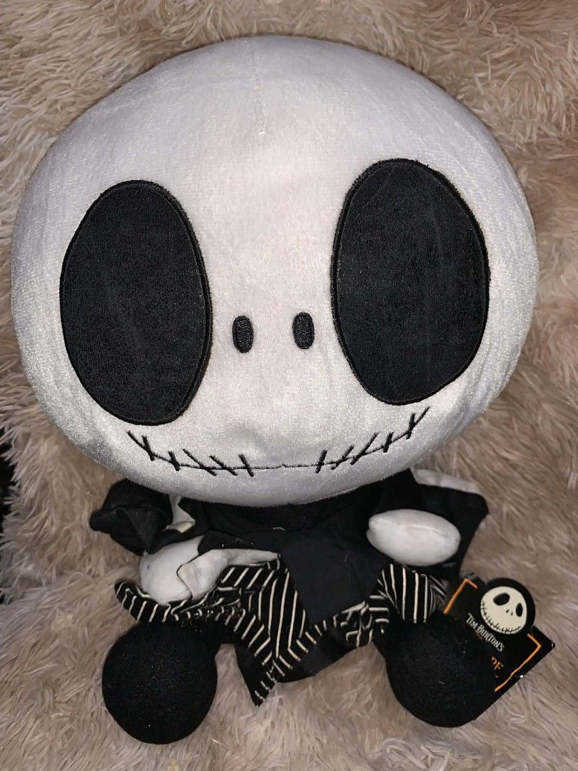 Tim Burton's The Nightmare Before Christmas Jack Plush (Category: Plushies & Soft Toys) located in Davao. Submitted by shopthrift (Listing ID 1426450992, Image 1). Description: Plush toy features Jack Skellington from Tim Burton's The Nightmare Before Christmas. It has a round head with large black eyes and a stitched mouth. Jack is wearing his signature black and white striped suit. The toy has a tag attached. It is a great collectible item for 