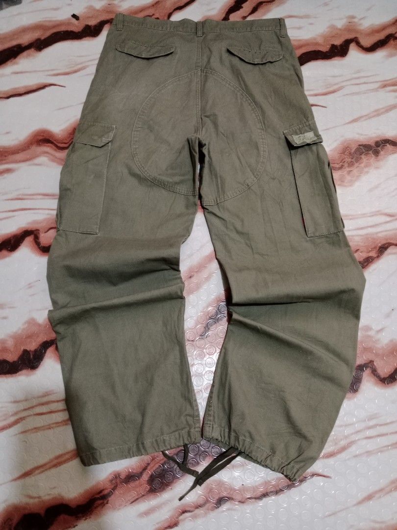 Wassup Cargo Pants - Olive Green - Size L (Category: Jeans) located in Roxas, Palawan. Submitted by cabreramed14075 (Listing ID 1426455453, Image 2). Description: Olive green cargo pants from Wassup. Features multiple pockets and adjustable drawstrings at the ankles. The pants have a button closure and a metal D-ring detail. Size L. Waist measures approximately 16 inches across. Inseam is approximately 30 inches. The pants appear to be made of a 