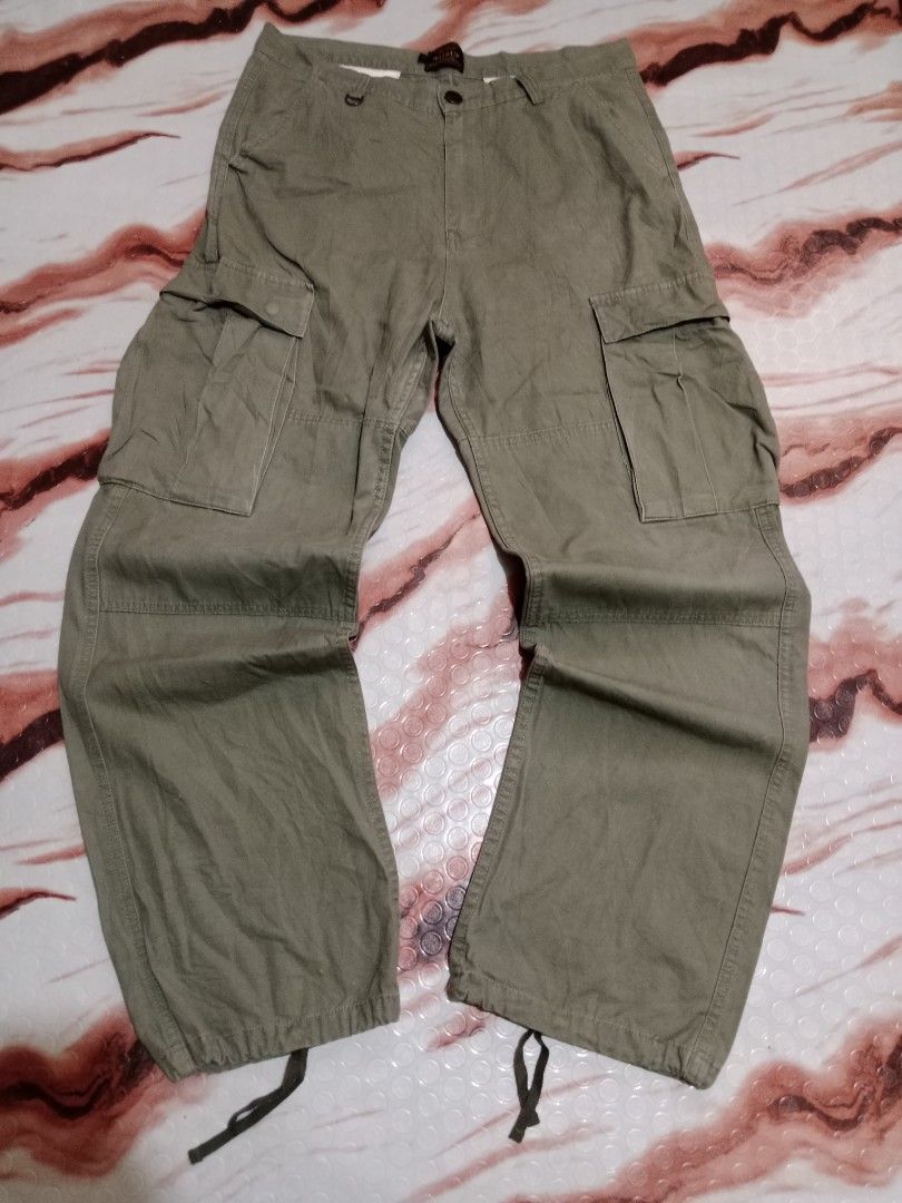 Wassup Cargo Pants - Olive Green - Size L (Category: Jeans) located in Roxas, Palawan. Submitted by cabreramed14075 (Listing ID 1426455453, Image 1). Description: Olive green cargo pants from Wassup. Features multiple pockets and adjustable drawstrings at the ankles. The pants have a button closure and a metal D-ring detail. Size L. Waist measures approximately 16 inches across. Inseam is approximately 30 inches. The pants appear to be made of a 