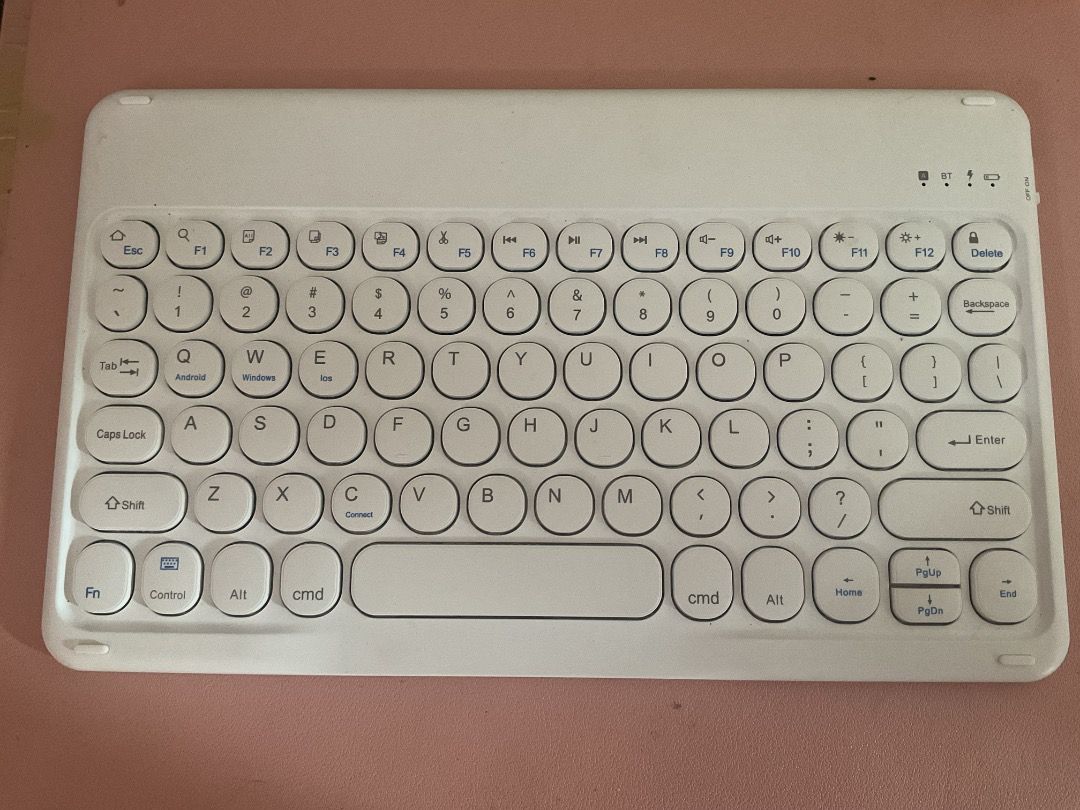 Wireless Bluetooth Keyboard (Category: Computer Keyboard) located in Manila. Submitted by rinangelic36923 (Listing ID 1426462197, Image 1). Description: White wireless Bluetooth keyboard. Features a full QWERTY layout with function keys and a dedicated delete key. Includes a charging port. It is compact and portable, suitable for use with tablets or other devices..