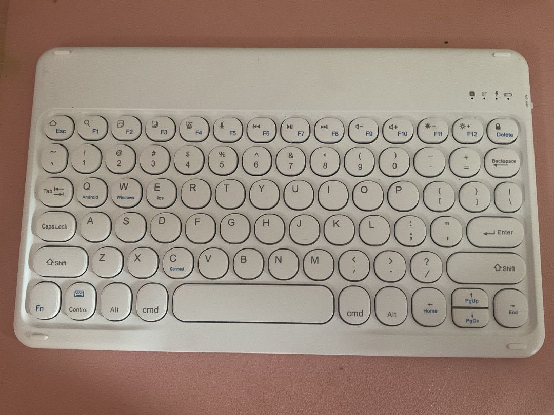 Wireless Bluetooth Keyboard (Category: Computer Keyboard) located in Manila. Submitted by rinangelic36923 (Listing ID 1426462197, Image 2). Description: White wireless Bluetooth keyboard. Features a full QWERTY layout with function keys and a dedicated delete key. Includes a charging port. It is compact and portable, suitable for use with tablets or other devices..
