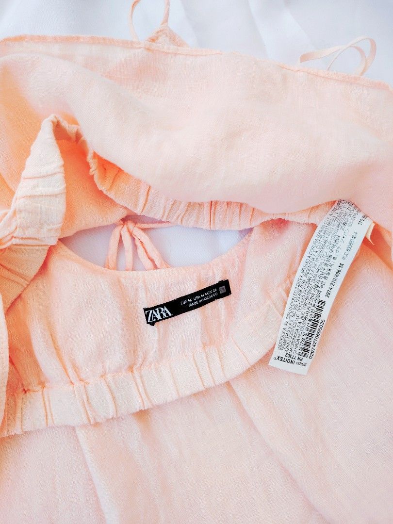 Zara Linen Peach Crop Top (Category: Others Tops) located in Cavite. Submitted by laraiaco (Listing ID 1426398217, Image 3). Description: Peach-colored crop top from Zara. Features spaghetti straps and a gathered neckline. The back has a tie detail. Made of a lightweight fabric. Perfect for a casual, summery look..