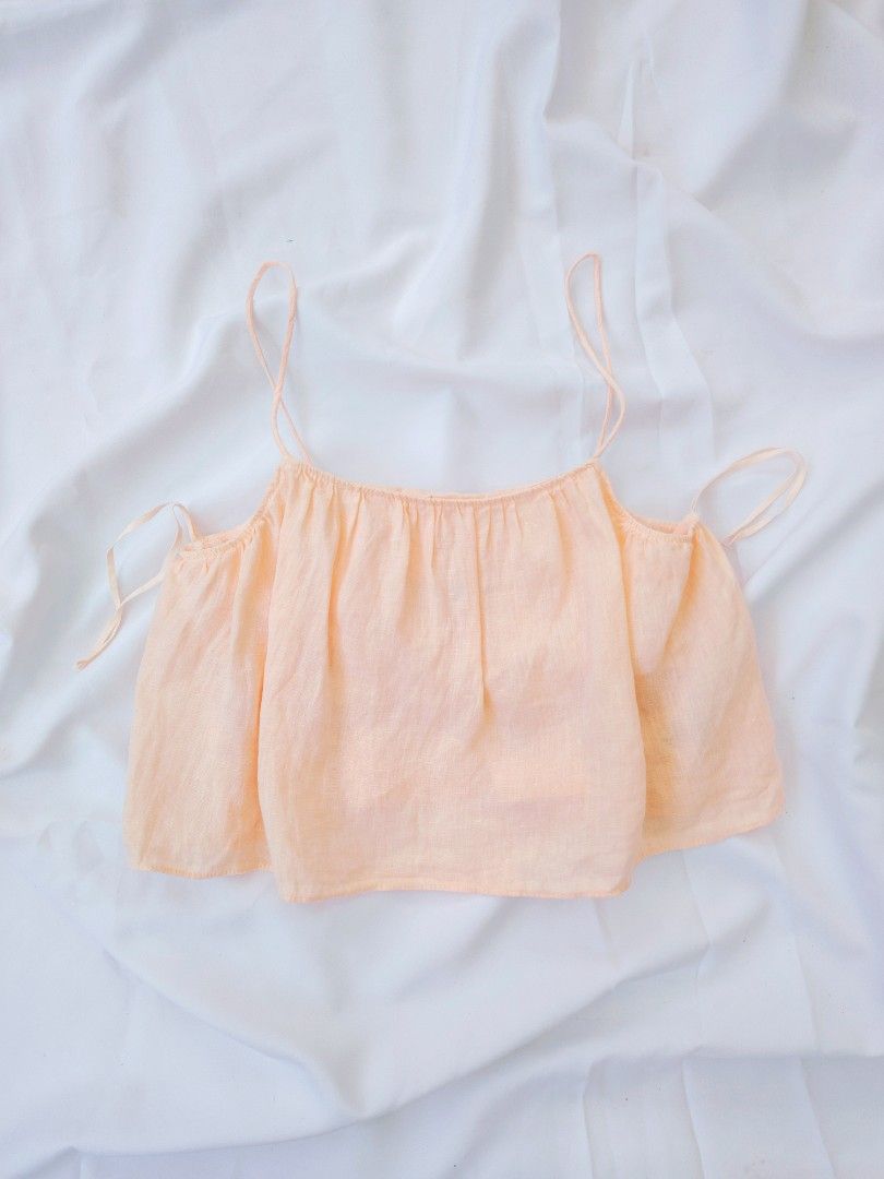 Zara Linen Peach Crop Top (Category: Others Tops) located in Cavite. Submitted by laraiaco (Listing ID 1426398217, Image 2). Description: Peach-colored crop top from Zara. Features spaghetti straps and a gathered neckline. The back has a tie detail. Made of a lightweight fabric. Perfect for a casual, summery look..