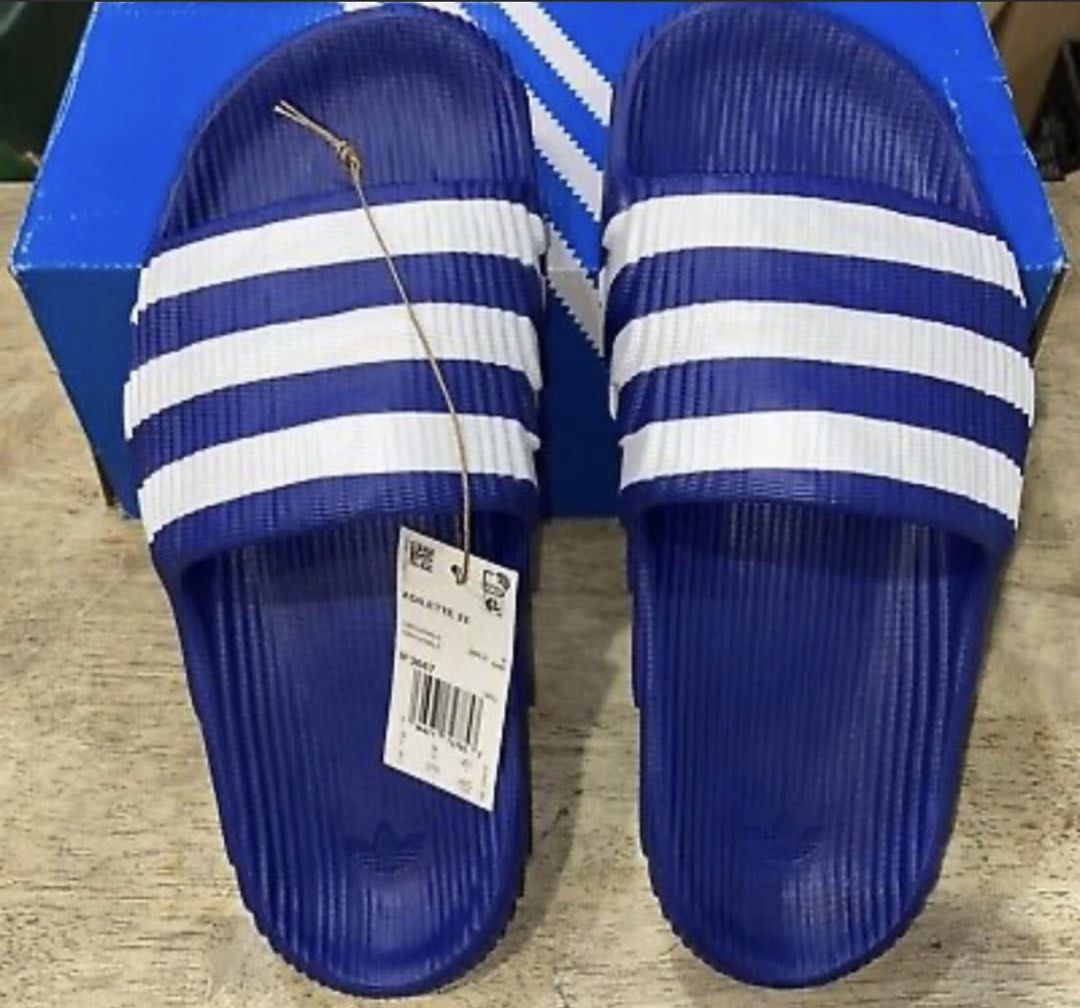 Adidas Adilette 22 Slides - Blue (Category: Slippers & Slides) located in Manila. Submitted by bornthisway22 (Listing ID 1426738523, Image 1). Description: Adidas Adilette 22 slides in blue with white stripes. The slides have the Adidas logo on the footbed. The original box is included. The size is indicated on the tag. The slides have a textured design on the footbed and the sole. The slides are new with tags..