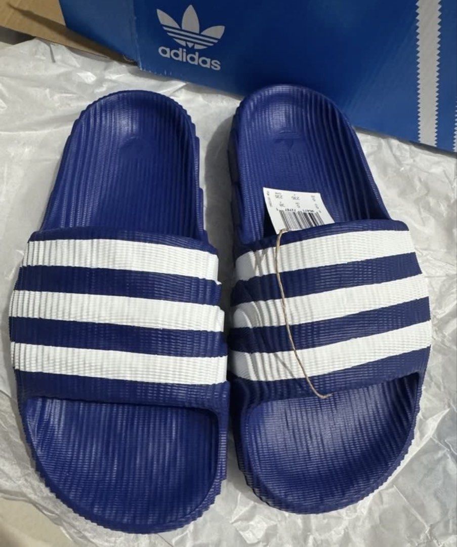 Adidas Adilette 22 Slides - Blue (Category: Slippers & Slides) located in Manila. Submitted by bornthisway22 (Listing ID 1426738523, Image 3). Description: Adidas Adilette 22 slides in blue with white stripes. The slides have the Adidas logo on the footbed. The original box is included. The size is indicated on the tag. The slides have a textured design on the footbed and the sole. The slides are new with tags..