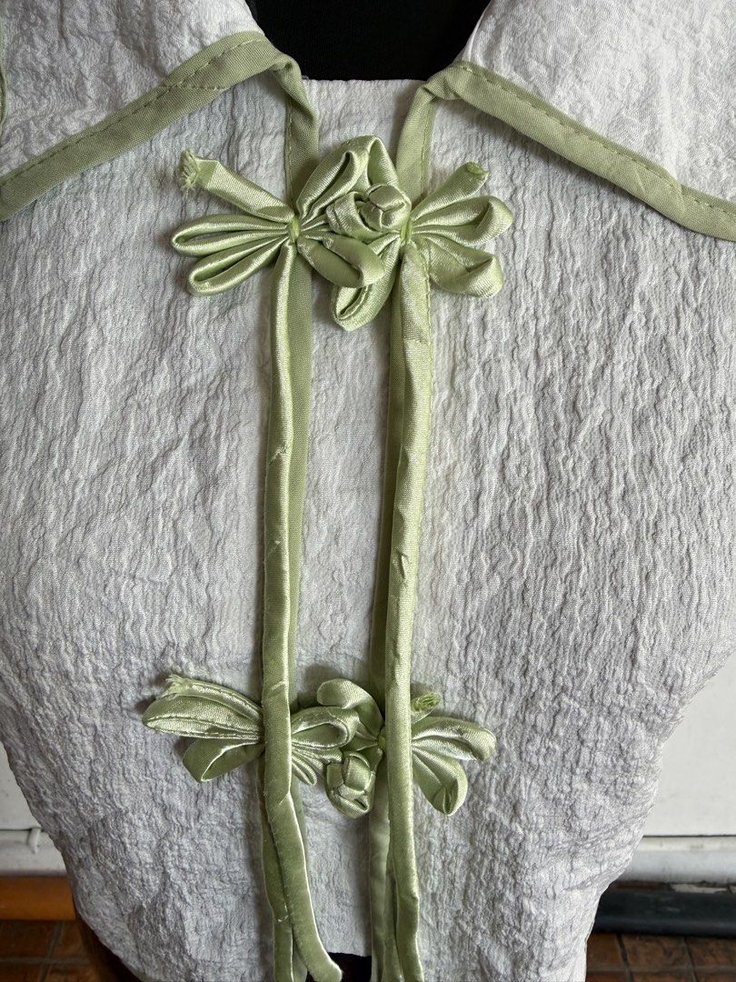 ASEAN Inspired Blouse (White & Sage Green) (Category: Sleeveless) located in Quezon City. Submitted by kweenbii (Listing ID 1426663239, Image 2). Description: Elegant ASEAN / Filipiniana inspired blouse with sage green accents 🌿 Perfect for government employees and professionals who wear Filipiniana / ASEAN attire every Monday. Classic design with traditional frog button details and a modern minimalist look. ✨ Details: • Textured white fabric • 