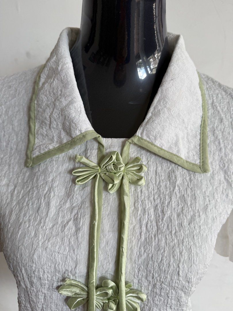 ASEAN Inspired Blouse (White & Sage Green) (Category: Sleeveless) located in Quezon City. Submitted by kweenbii (Listing ID 1426663239, Image 3). Description: Elegant ASEAN / Filipiniana inspired blouse with sage green accents 🌿 Perfect for government employees and professionals who wear Filipiniana / ASEAN attire every Monday. Classic design with traditional frog button details and a modern minimalist look. ✨ Details: • Textured white fabric • 
