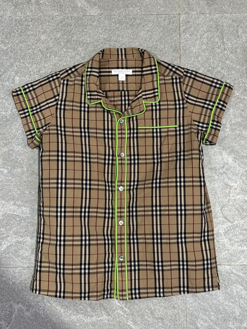 Authentic Burberry Checkered Shirt 12YO on tag (152cm) (Category: Babies & Kids Fashion) located in Cebu City. Submitted by llben07 (Listing ID 1426650485, Image 1). Description: Burberry kids shirt in a classic checkered pattern. Features a collared neckline, short sleeves, and neon green trim. The shirt has button closures down the front. Made from 100% cotton. Size is 12Y. Made in China..