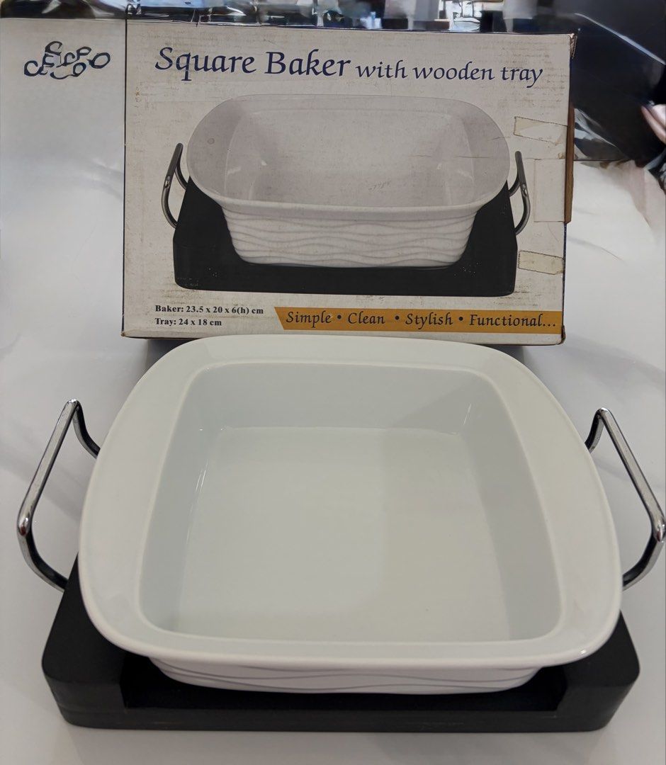 Bakeware with wooden tray (Category: Bakeware) located in Pasig City. Submitted by gedi_c (Listing ID 1426620676, Image 2). Description: Ceramic Square Baker with Wooden Tray / Serving Stand Elegant ceramic baking dish with wooden serving tray. Perfect for casseroles, baked pasta, lasagna, or desserts. Can go straight from oven to table for serving. Includes:• Ceramic square baking dish• Wooden tray with metal handles• Original box Size:Baker – 2