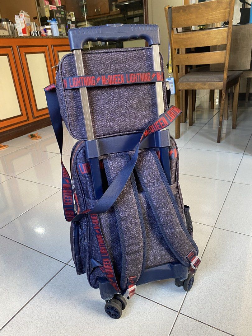 Disney Cars Rolling Backpack (Category: Strollers) located in Quezon City. Submitted by babyshark0203 (Listing ID 1426791101, Image 2). Description: Pre-loved Disney Cars Lightning McQueen rolling school bag in good condition. Perfect for preschool or grade school kids who have heavy books. Features: • Rolling wheels + pull handle (trolley style) • Multiple compartments for books, lunchbox, and supplies • Durable material and sturdy zippers • Fun