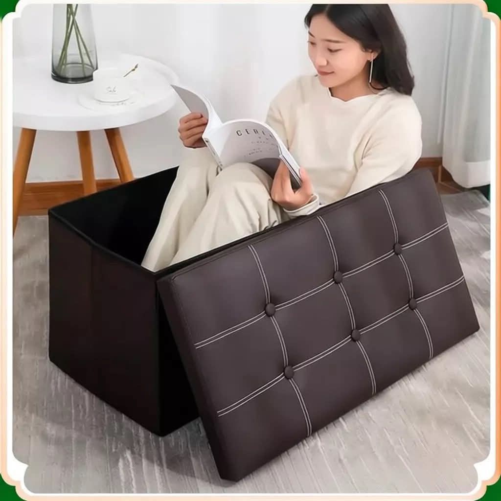 Foldable storage sofa box (Category: Storage Boxes & Baskets) located in Manila. Submitted by jelai.cybyb (Listing ID 1426784888, Image 3). Description: Foldable storage ottoman features a buttoned top and is available in various colors. It can be used as a seat or for storing items. The ottoman has a brown exterior and a black interior. It is a versatile piece of furniture suitable for any room..