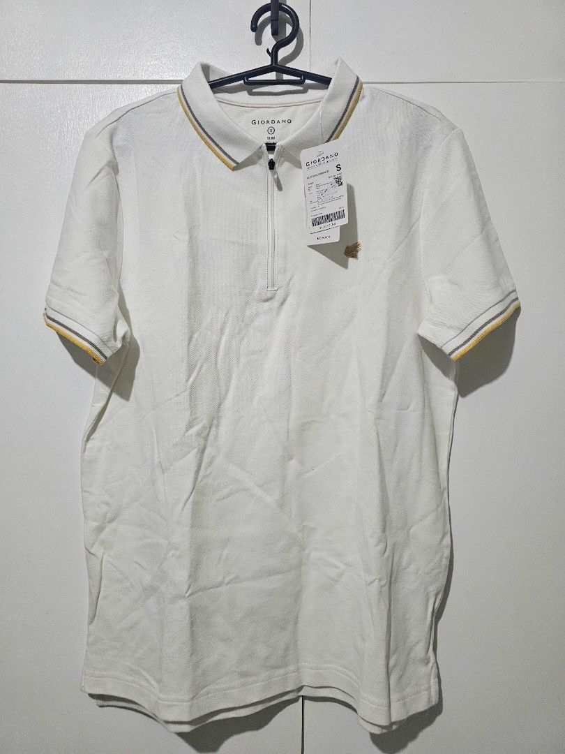 Giordano Polo Shirt - White (Category: Shirts) located in Balanga. Submitted by clearchaos (Listing ID 1426661451, Image 2). Description: White Giordano polo shirt. Features a zipper closure and a collar with yellow and gray accents. The shirt has short sleeves with matching yellow and gray trim. Includes the original tags. Size is Small..