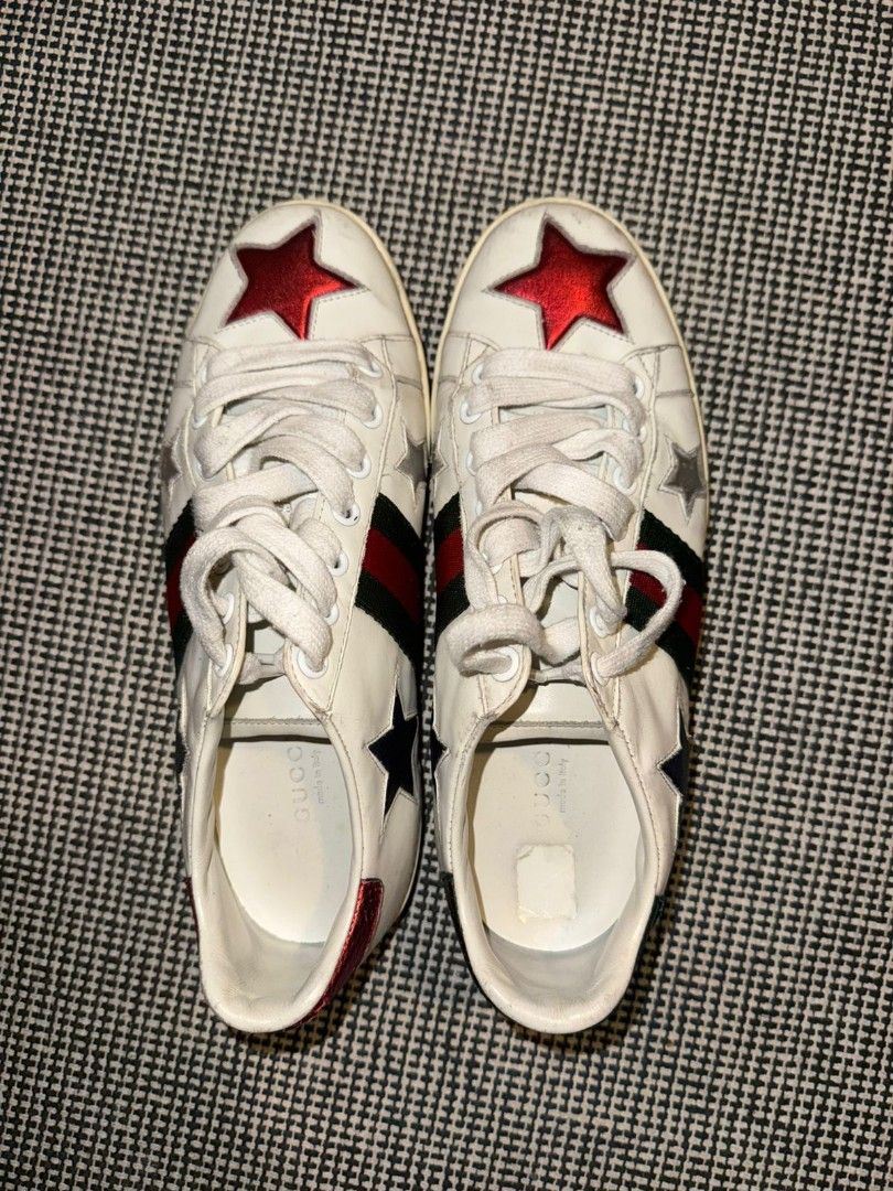 Gucci Star Ace Sneakers (Category: Sneakers) located in Makati City. Submitted by chris_angle (Listing ID 1426608573, Image 1). Description: Authentic Gucci Ace sneakers featuring a white leather upper with star appliqués. The iconic green and red stripe is visible on the sides. The heel tabs are in red and green with Gucci branding. The insoles are marked with "Gucci made in Italy". Meetup in Uptown Mall or Starbucks Avida Verte Shipping can be 